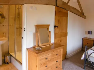 a bathroom with a wooden dresser with a mirror on it at The Old Cider Mill in Farden