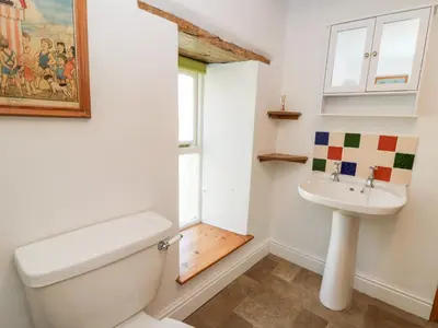 a bathroom with a toilet and a sink at The Farmhouse in Ciliau-Aeron