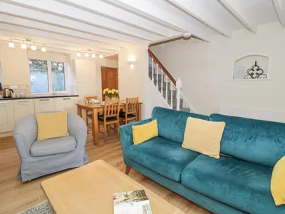 a living room with a couch and a table at Ty Gwyn in Aberdyfi