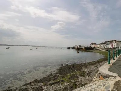 a large body of water with houses on the shore at Ty Gwyn in Aberdyfi