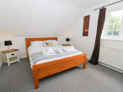 a bedroom with a bed with two towels on it at Cariad Cottage in Cilcennin