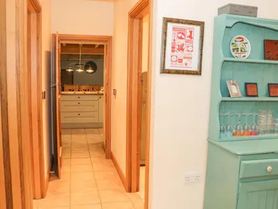 a hallway with a blue cabinet in a room at The Old Mill in Llanfihangel Rhydithon