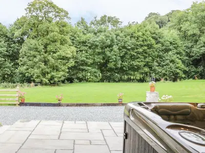 a view of a garden from the porch of a house at The Old Mill in Llanfihangel Rhydithon