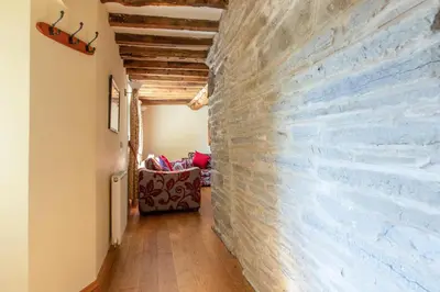 a hallway with a brick wall in a house at Maesgwyn in Felindre