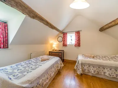a bedroom with two beds and a window at Stone House in Ludlow