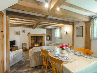 a dining room with a table and a bed at Stone House in Ludlow