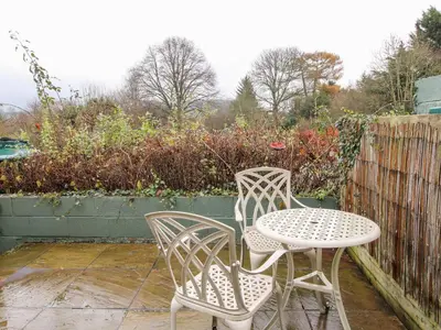 two chairs and a table on a patio at Castle Cottage in Clun