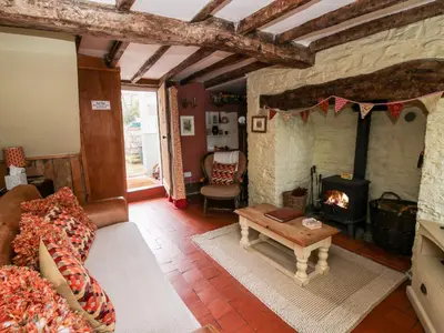 a living room with a couch and a fireplace at Castle Cottage in Clun
