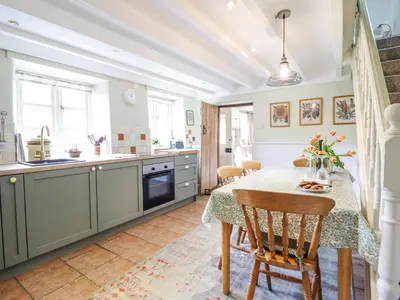 a kitchen with a table and chairs in a room at Haulfryn in Llangynog