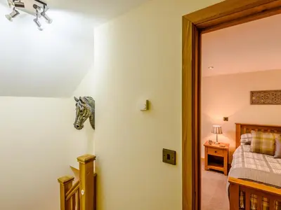a bedroom with a horse head on the wall at The Stables in Llanfair Caereinion