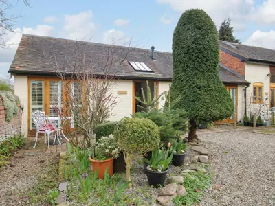 a garden in front of a house with plants at The Milking Parlour in Leominster