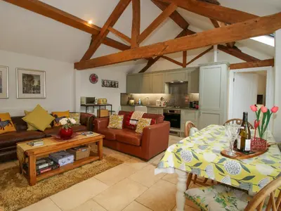 a living room with a couch and a table at The Milking Parlour in Leominster