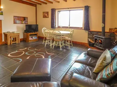 a living room with a couch and a table at Y Bwthyn in Ystrad Meurig
