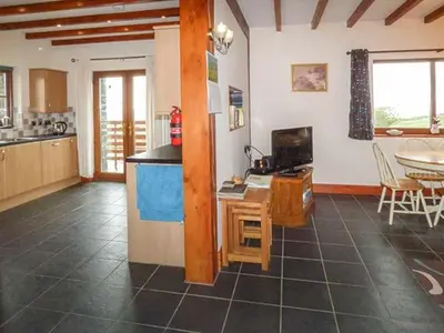 a kitchen with a counter and a table in a room at Y Bwthyn in Ystrad Meurig