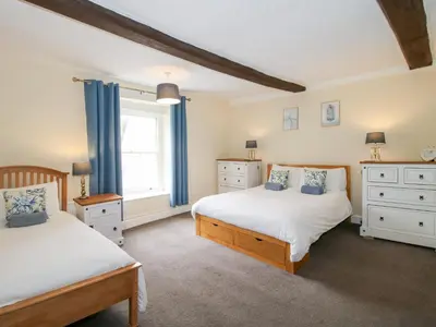a bedroom with two beds and a window at The Laurels in Bishops Castle