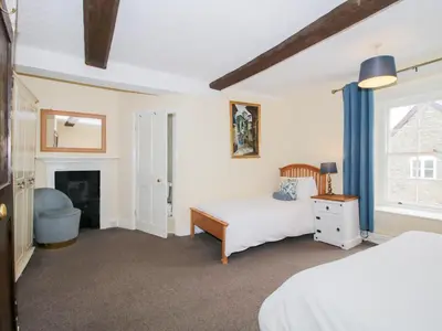 a bedroom with two beds and a fireplace at The Laurels in Bishops Castle