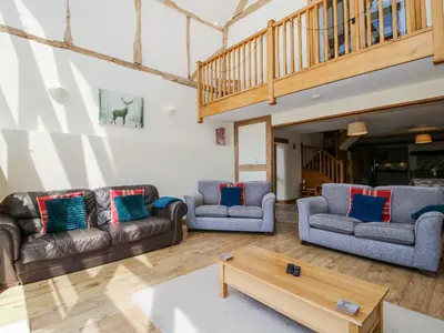 a living room with couches and a coffee table at The Hayloft in Knighton