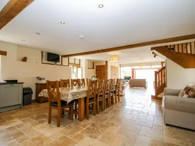 a kitchen and dining room with a table and chairs at The Hayloft in Knighton