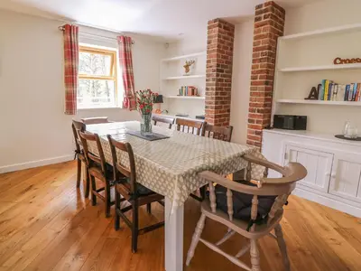 a dining room with a table and chairs at The Farmhouse in Capel Bangor