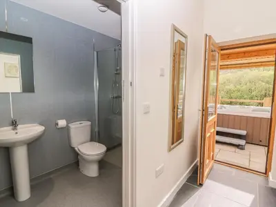 a bathroom with a toilet and a shower and a sink at The Farmhouse in Capel Bangor