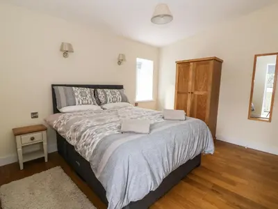 a bedroom with a bed with two towels on it at Y Felin - Moana in Borth