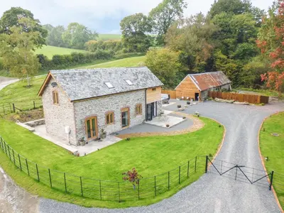 an aerial view of a farm house with a driveway at Tynddol Barn in Llanbadarn-fynydd