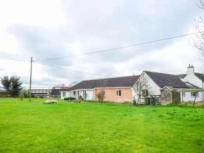 a house in a field with a green yard at The Willows in Ellesmere