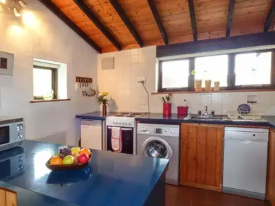 a kitchen with a bowl of fruit on a counter at Ty Uchaf in Llangwm