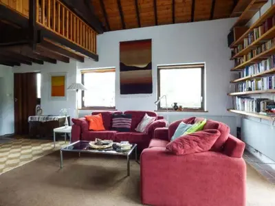 a living room with two red couches and a table at Ty Uchaf in Llangwm