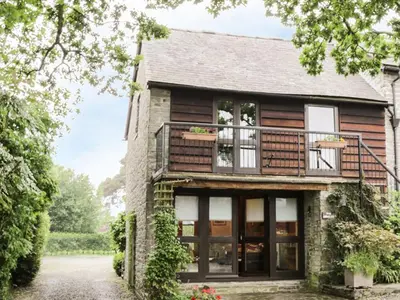 a house with large windows and a balcony at The Granary in Bucknell