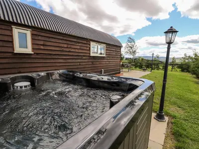 a swimming pool in front of a house at Meadow View in Saint Harmon