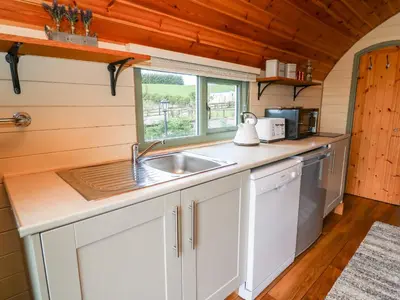 a kitchen with a sink and a window at Meadow View in Saint Harmon