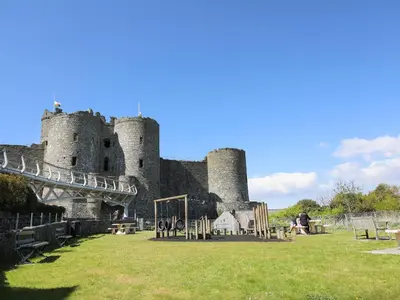 a castle with a playground in front of it at Bwthyn Bach in Llanddwywe