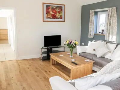 a living room with a couch and a coffee table at Swallow Barn in Walford