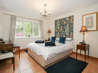 a bedroom with a bed and a desk and a window at Riverdale in Shrewsbury