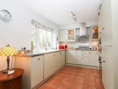 a kitchen with white cabinets and a window at Riverdale in Shrewsbury