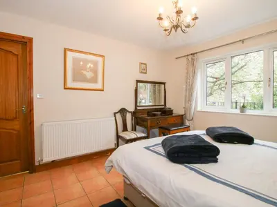 a bedroom with a bed and a desk and a window at Riverdale in Shrewsbury