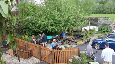 a group of people standing in a garden at The Harp Inn in Glasbury