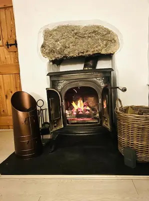a fireplace in a living room with a fire place at Pen Y Bont Cottage Llanuwchllyn Bala in Llanuwchllyn