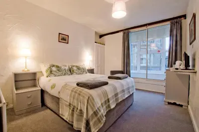a bedroom with a bed and a large window at The Owls in Builth Wells