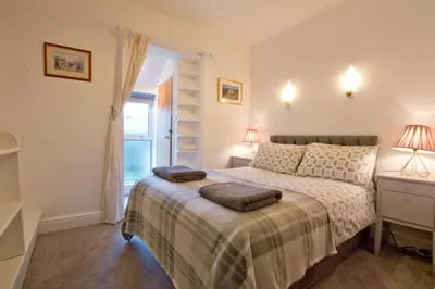 a bedroom with a bed with two pillows on it at The Owls in Builth Wells