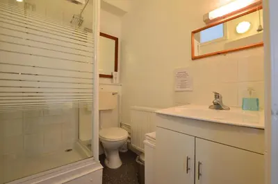 a bathroom with a toilet and a sink and a shower at The Owls in Builth Wells
