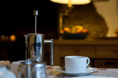 a coffee maker and a cup on a table at The Owls in Builth Wells