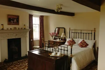a bedroom with a bed and a fireplace at Hordley Hall in Ellesmere