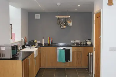 a kitchen with a sink and a stove top oven at Capel- Y-Bryniau in Pennal