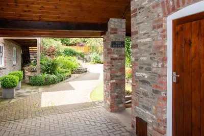 an entrance to a brick building with a wooden door at Wye Cottage in Builth Wells