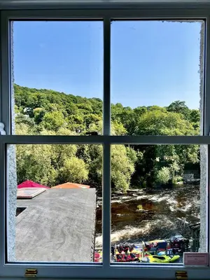 a view of a river from a window at RIVERBANC in Llangollen