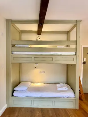 a room with two bunk beds in it at RIVERBANC in Llangollen