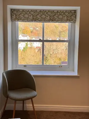 a chair sitting in front of a window at RIVERBANC in Llangollen