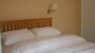 a bed with two white pillows on top of it at The Keep in Ludlow
